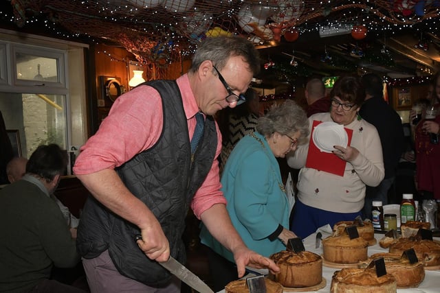 Judge Mark Nockels examines a pie..