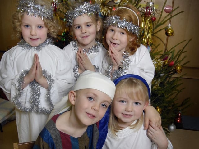 Angels Bethany Smith, Imogen Coates, and Kelsey Smith, with Taylor Moulds as Joseph, and Megan Webster as Mary.