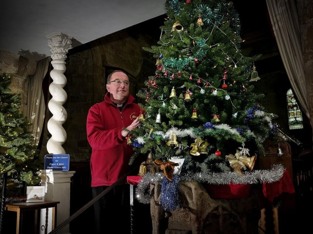 Father Michael Gobbett views one of the trees, 195224n