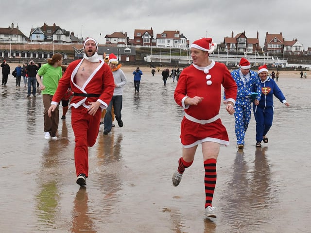 Santa makes a dash for the waves.