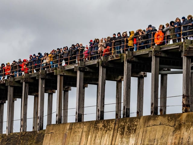 A large crowd watches the action.