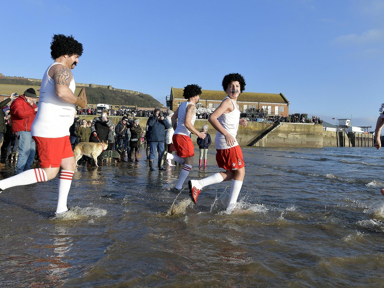Runners enter the water.