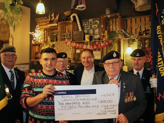 Jordan Padgham, centre, presents a cheque for 215 to legion members, watched by Paul Grahamslaw, representing the Walk to Run group.