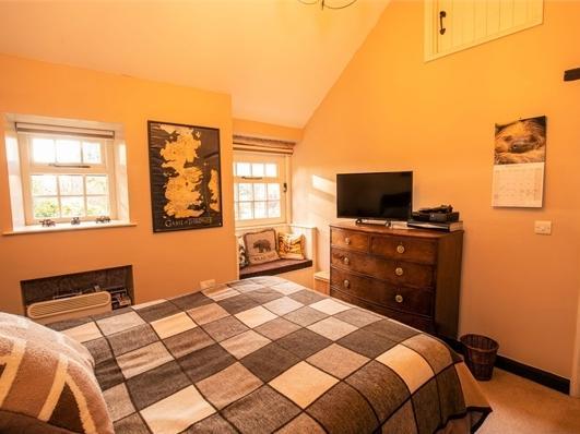 Another of the five bedrooms with plenty of light from the windows.