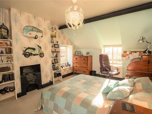 A third sunny bedroom complete with cast iron fireplace.