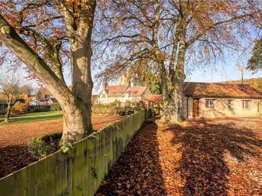 More of the outdoor space which includes a stable block, barns, garden and paddock.