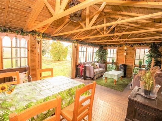 A beautiful conservatory area looking out to the grounds, the perfect spot to while away a few summer hours.