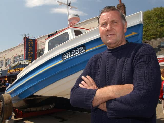 Jim in front of his coble. Picture: JPI Media
