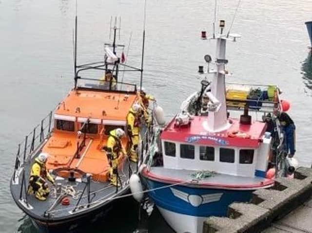 The lifeboat and the rescued vessel in Scarborough Harbour. Picture: RNLI/ Michael Bayes