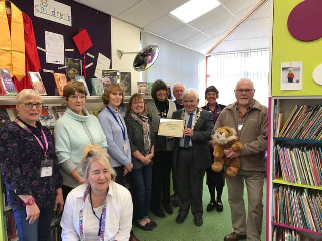 Library staff and volunteers at Filey library receive a Summer Reading Challenge award from Cllr Jim Clark.