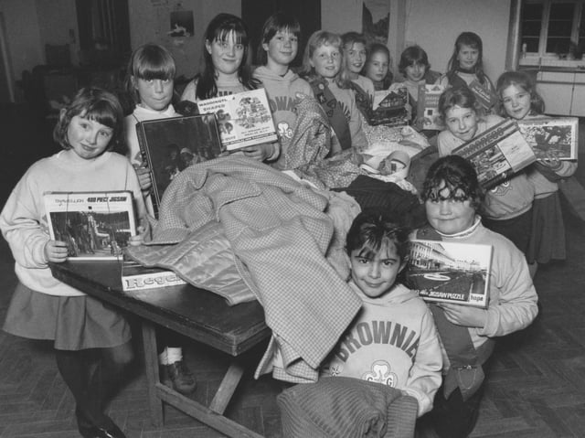 St James' Church Brownies were all set for their fundraising jumble sale in January 1995. The girls are pictured sorting through their collection of games and clothing.