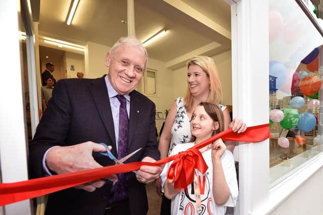 Harry Gration cuts the ribbon with Age UK Chief Executive Julie Macey- Hewitt and daughter Gracie Mae Bell.