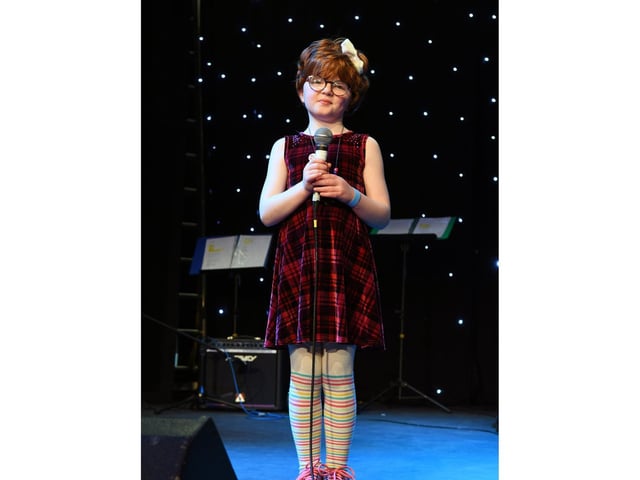 A youngster has a go on stage.