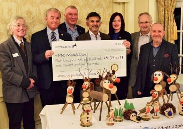 Jenn Dodd, regional fundraiser for the MND Association is presented with the cheque for £4,375 by The Rotary Club of Scarborough Cavaliers.