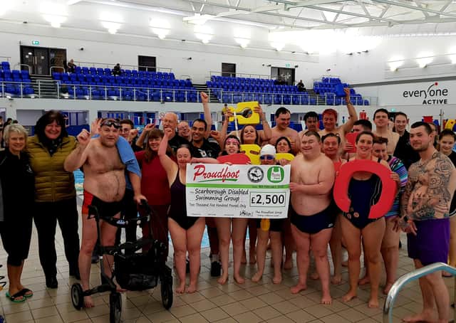 Scarborough Disabled Swimming Group is presented with a cheque from the Proudfoot Group for £2,500.