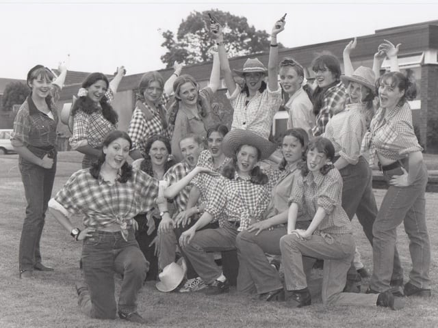An annual tradition at St Augustine's School is an end of term theme day when everyone dresses up - the theme in 1997 was the movies. Vickie Wyatt, front, as Calamity Jane, who leads the line up singing their version of The Deadwood Stage, called The Old Brid' Bus!
