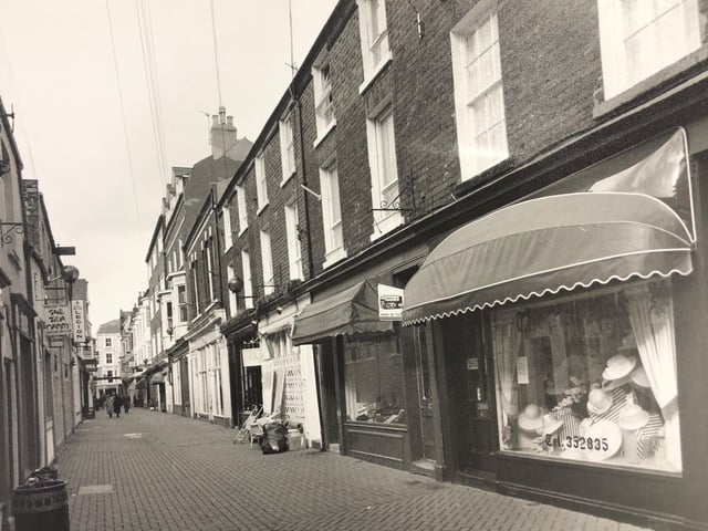A hat and a camera shop at the bottom end of Bar Street.