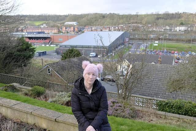 Tina Ford in her garden with the train depot in the background. Picture: JPI Media/ Richard Ponter
