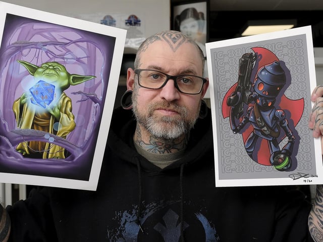 Dan with some of his digital artwork.