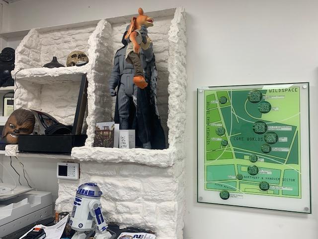 Shelves of Star Wars memorabilia and left, an interactive map of the town.
