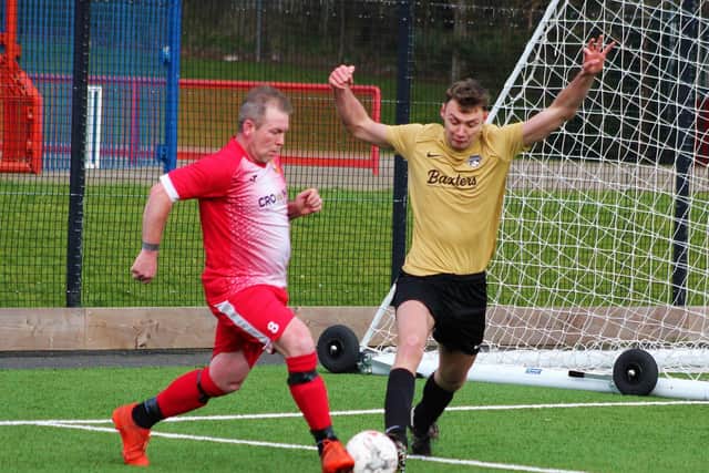 Edgehill Reserves veteran Gary Hepples tries to get past Max Edwards of Cayton Athletic