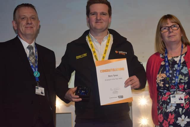 Adam Weston at Boro Tyres is presented with the YES Employer of the Year Award by Alan Hadfield, Head of Apprenticeships and Ann Hardy, Principal of Scarborough TEC.
