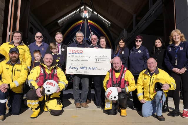 Tesco Staff join Scarborough Lifeboat crew and supporters for a 25,00 cheque presentation with Lifeboat Operations Manager Andy Volans receiving the cheque from Tesco Manager Christopher Windsor Picture: JPI Media/ Richard Ponter