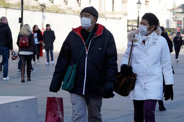 Shoppers wear surgical masks in central London. Photo: Getty Images