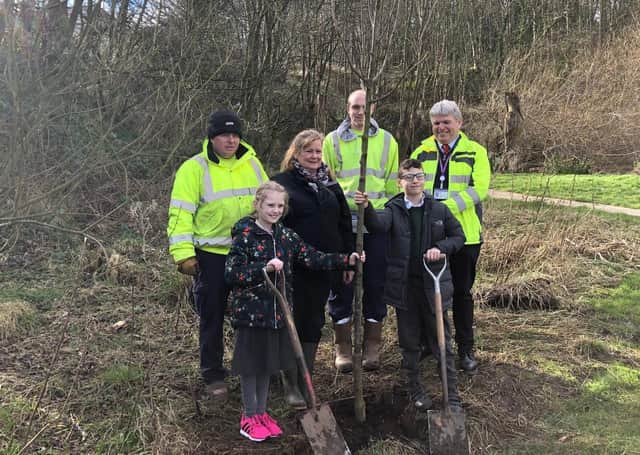 Springhead School pupils Bethany McHale (9) and Oliver Wilson (11) plant a tree with Cllr Liz Colling and members of Scarborough Council’s Parks team.