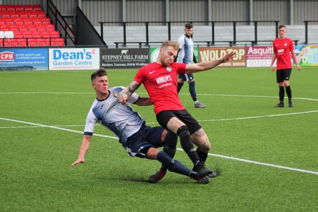 Edgehill's Ryan Link makes a sliding challenge on Itis Itis' Jordan Oliver
PHOTOS BY ALEC COULSON