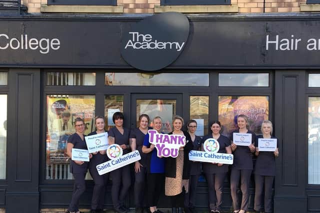 Lisa Grattan (beauty lecturer) and Naomi Blades (Saint Catherines fundraising team leader) with students from The Academy