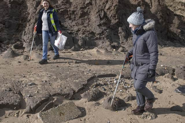 Scouring the beach for rubbish