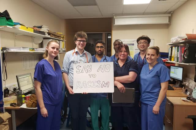 Dr See and some of his colleagues urging people to speak out against racism.