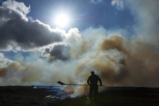 5 March 2020.... A heather beater keeps a close watch on a controlled heather burn on the moors above Castleton in the North Yorkshire Moors National Park. Technical details Nikon D3s wuith a 28-70mm lens and an expoure of 1/2500th @f9, 200 ISO. Picture Tony Johnson
