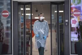An ambulance staff member wearing PPE at St Thomas' Hospital in London yesterday. Picture: Victoria Jones/PA