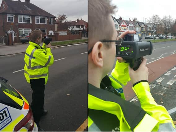 Police using a speed gun on drivers.