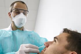 A doctor testing a patient suspected of having Covid-19 (photo: Salvatore Di Nolfi/Keystone via AP).