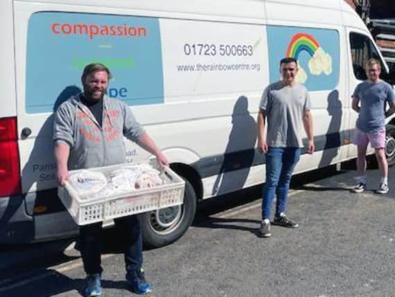 Hideout Manager Jordan Padgham and representatives of the Rainbow Centre with some of the Cooplands food parcels.