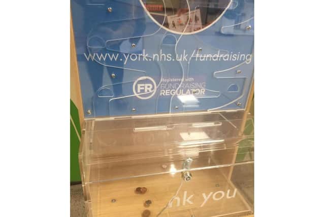 The charity box after being broken into.