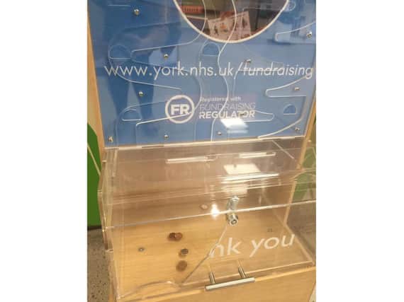 The charity box after being broken into.