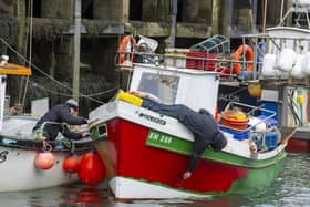 Fishermen do some maintenance during lockdown. Picture: JPI Media/ Tony Johnson