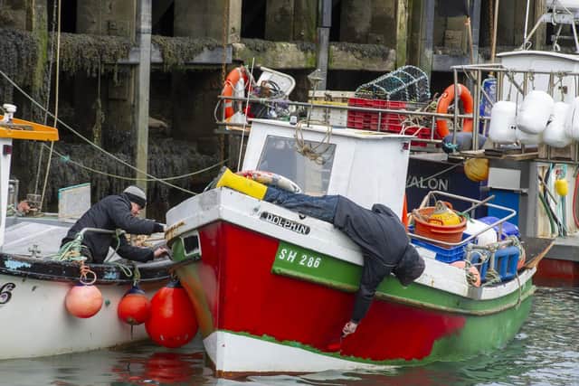 Fishermen do some maintenance during lockdown. Picture: JPI Media/ Tony Johnson