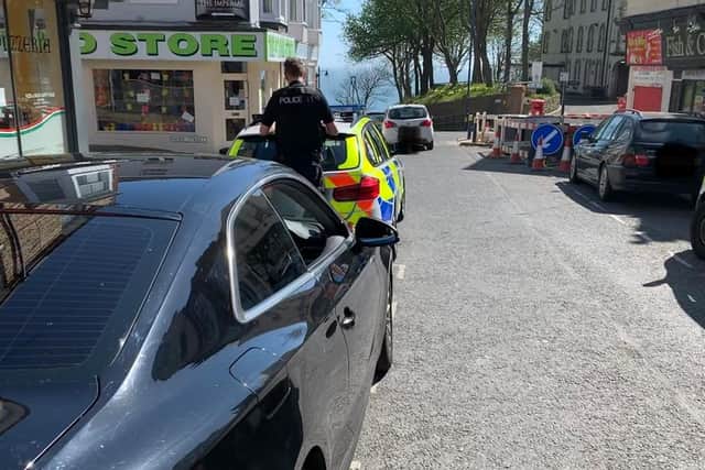 Officers in Filey dealing with the driver. Picture from North Yorkshire Police.