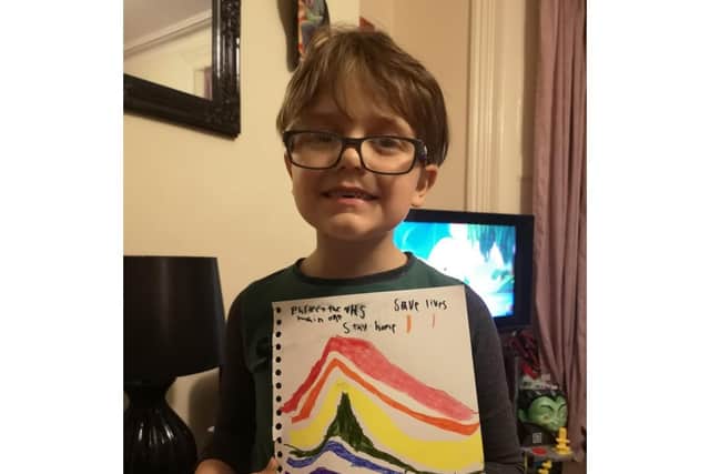 Jasper Raven with his Stay Home, Save Lives poster