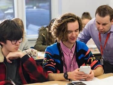 Scarborough Sixth Form College Maths Teacher John Armstrong before the lock down, with students Alfie Kellett (left) and Tobias Cooper (right).