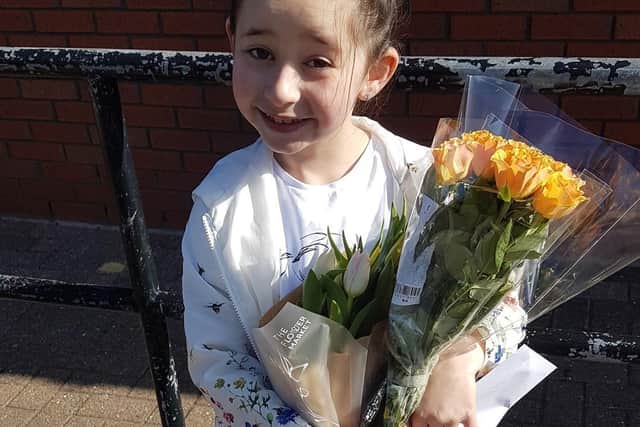 Polly Mayo with the flowers she bought.