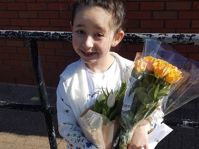 Polly Mayo with the flowers she bought.