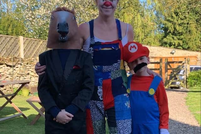 Mum Angela Saunders with children Robin and Felix, donning fancy dress for their daily walks.