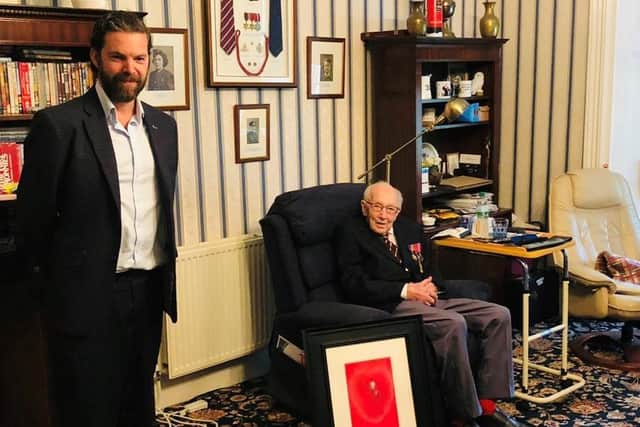 Royal portrait artist Darren Baker (left) presenting Captain Tom Moore with a pastel portrait of himself. Mr Baker also gave the veteran a sketch of Keighley, West Yorkshire. Picture: PA