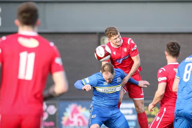 Harry Spratt wins a header during his loan spell from York City